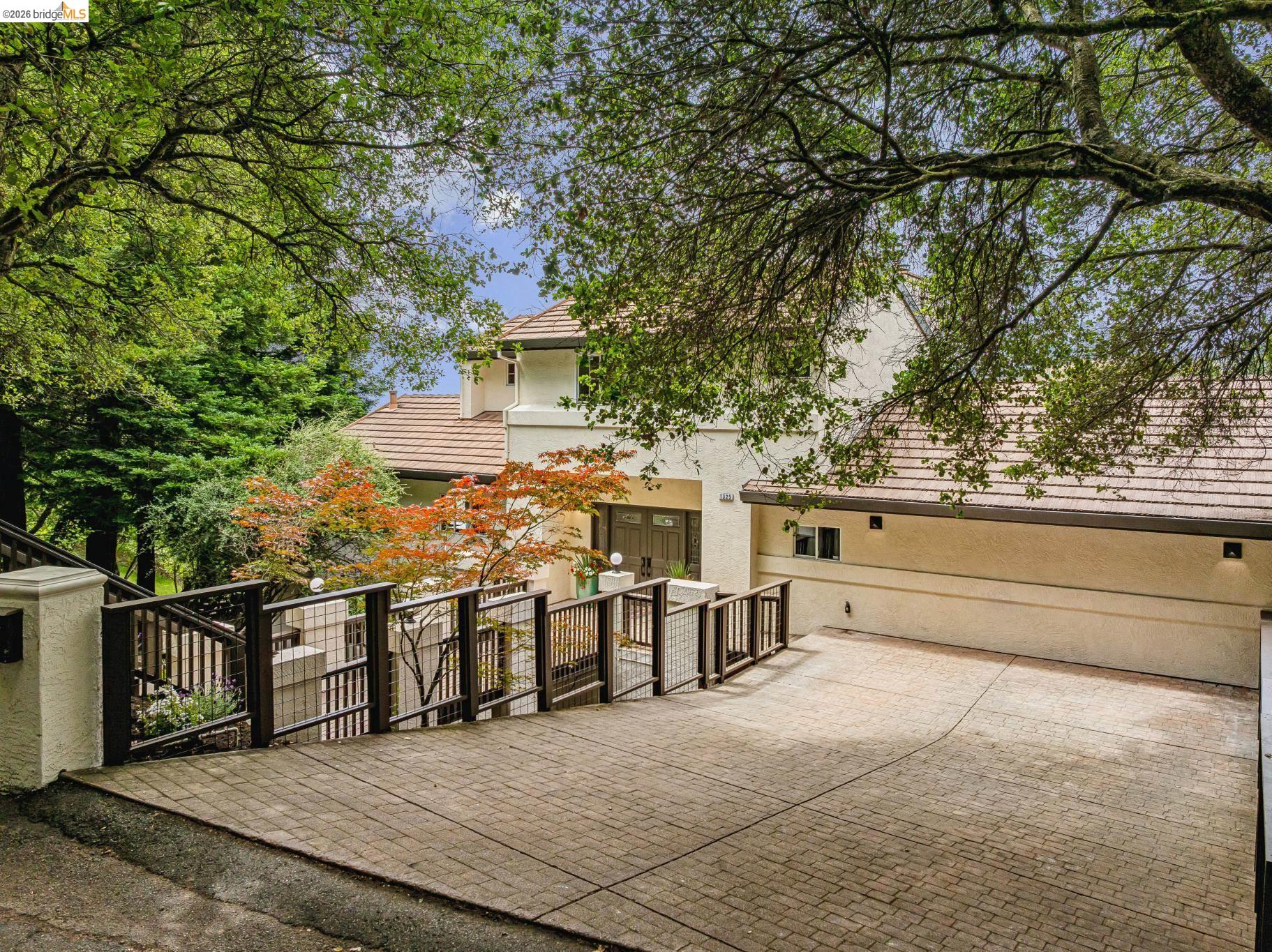 1325 Drury Road Berkeley, CA 94705 - Photo 68 of 71 Stucco exterior with a tile roof and a paved driveway