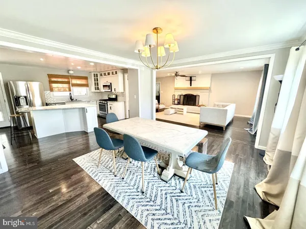 a living room with furniture dining table and wooden floor