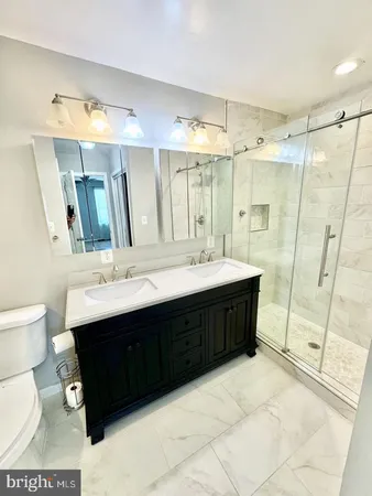 a bathroom with a sink double vanity and a mirror