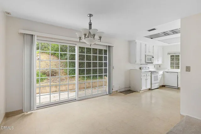 a view of a kitchen with large windows