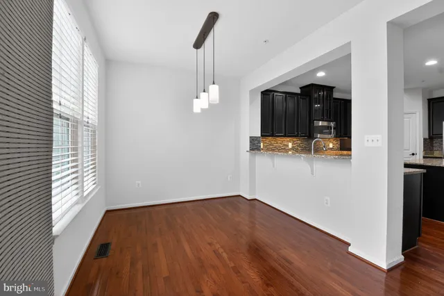 a view of a room with wooden floor and window