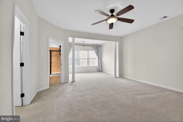 a view of empty room with ceiling fan