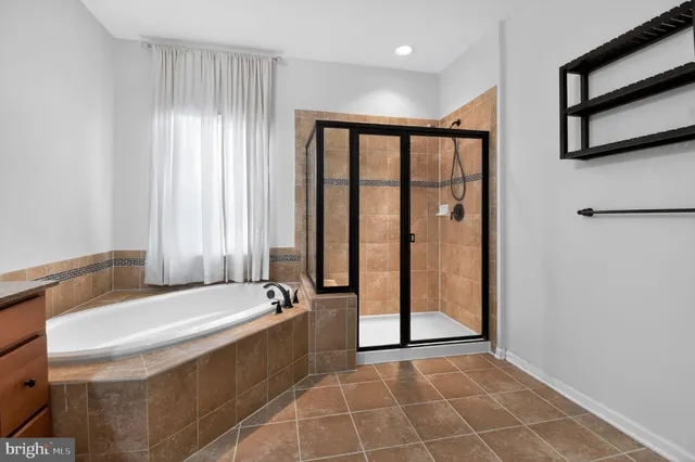 a spacious bathroom with a tub and shower