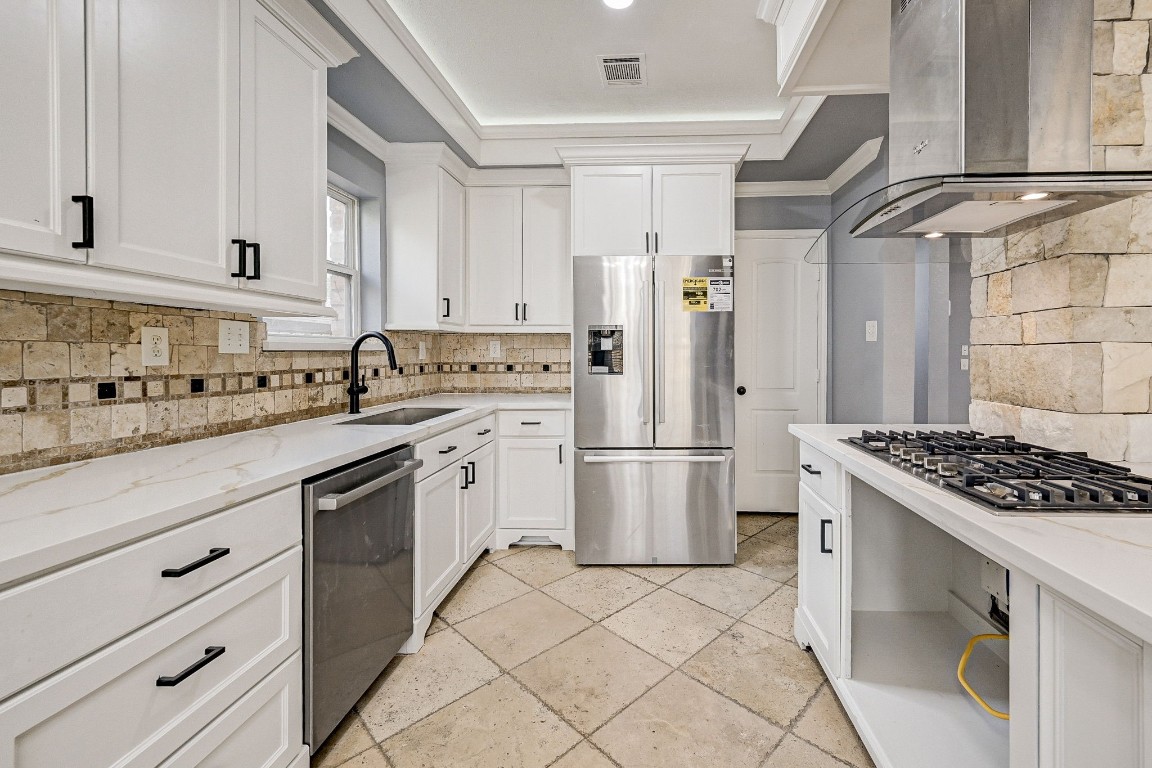 3306 Gary Lane Spring, TX 77380 - Photo 16 of 49 a kitchen with stainless steel appliances granite countertop a stove a refrigerator and a white cabinets