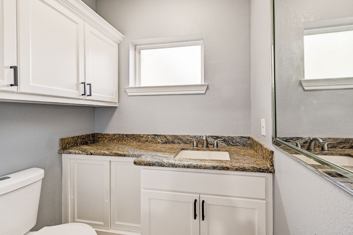 3306 Gary Lane Spring, TX 77380 - Photo 29 of 49 a bathroom with a granite countertop sink and a toilet