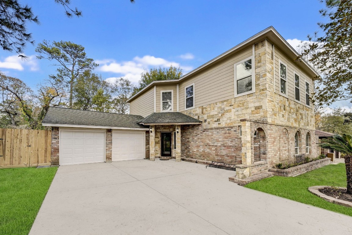 3306 Gary Lane Spring, TX 77380 - Photo 4 of 49 a front view of a house with a garden and trees
