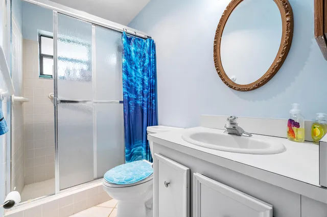 a bathroom with a sink toilet and a mirror