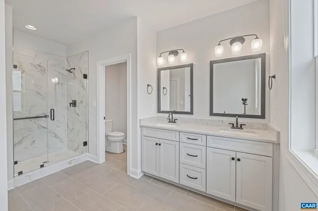 a spacious bathroom with a double vanity sink mirror double and shower