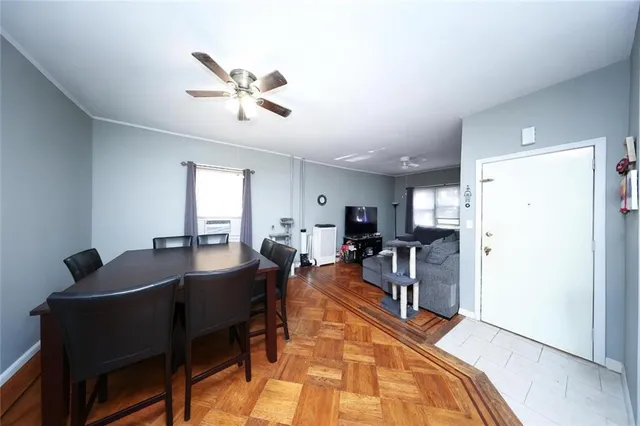 a living room with furniture a large window and stainless steel appliances