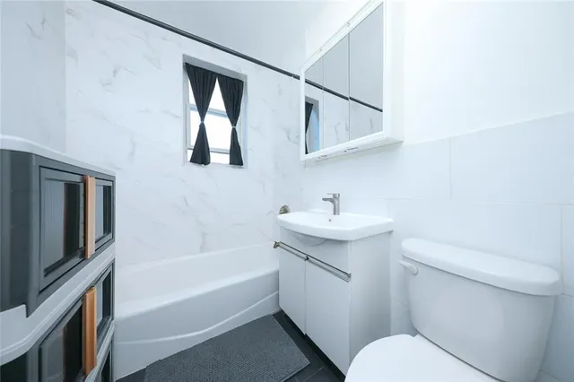 a bathroom with a sink toilet and bathtub