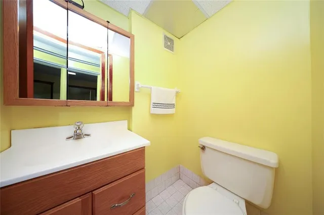 a bathroom with a sink mirror and toilet
