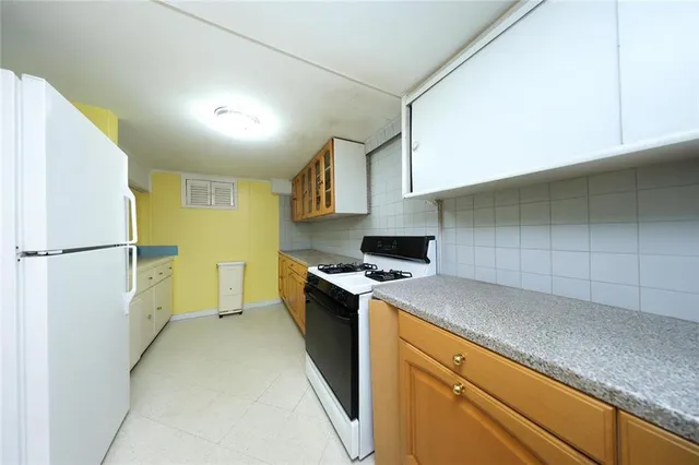 a kitchen with a sink a stove and a refrigerator