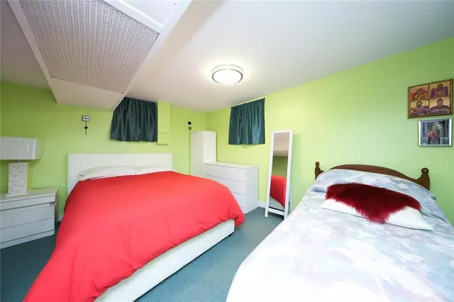 a bedroom with a bed and a large window