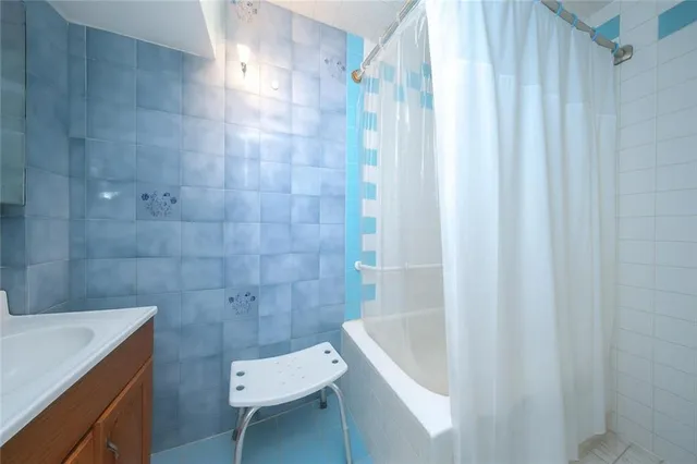 a bathroom with a tub a sink and a toilet