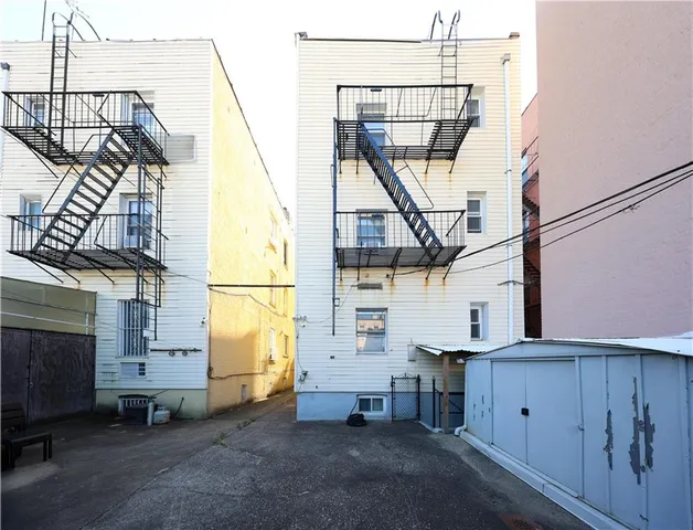 a view of a house with wooden deck and furniture