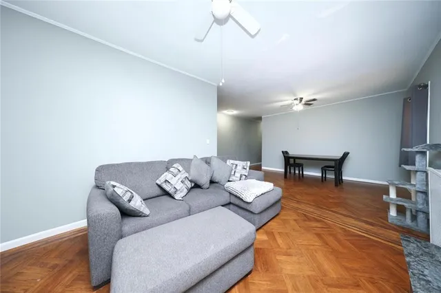 a living room with furniture and a chandelier