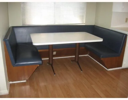 a view of a room with furniture and wooden floor