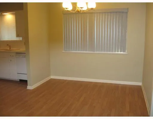 an empty room with wooden floor