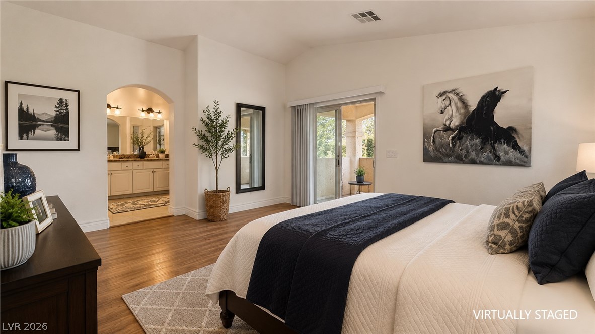 87 Tall Ruff Drive Las Vegas, NV 89148 - Photo 60 of 71 Hardwood flooring extends throughout this naturally illuminated primary bedroom, which features a private balcony.