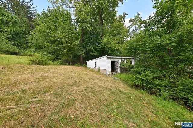 a backyard of a house with trees and plants