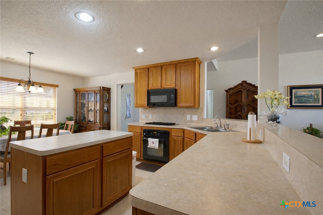 9439 Jeske Road Needville, TX 77461 - Photo 19 of 46 a large kitchen with stainless steel appliances a stove a sink a oven and a refrigerator