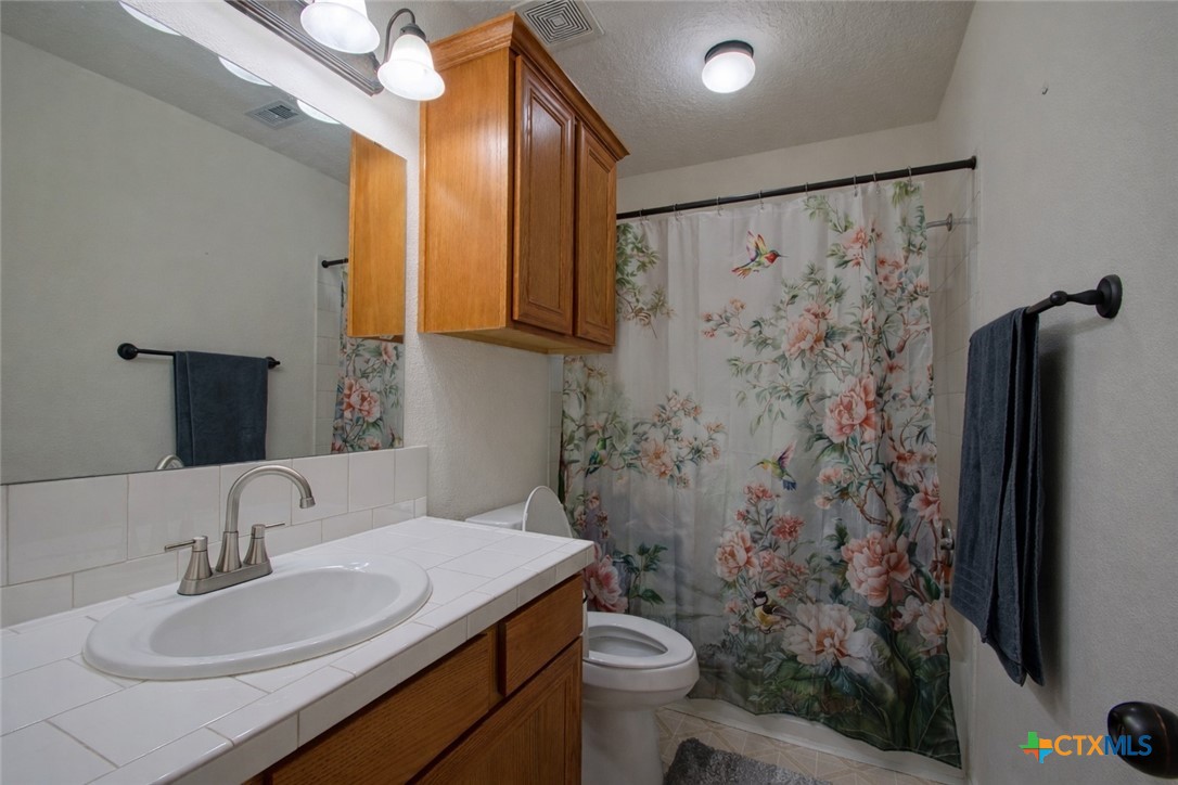 9439 Jeske Road Needville, TX 77461 - Photo 28 of 46 a bathroom with a sink toilet and shower