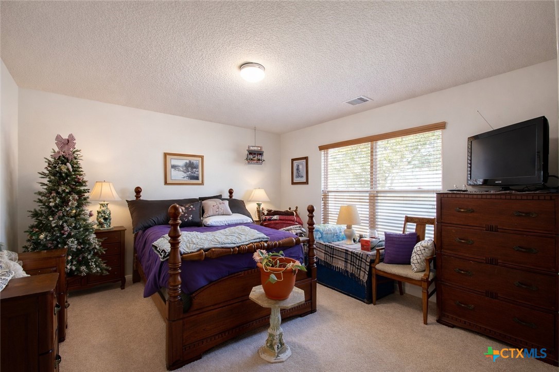 9439 Jeske Road Needville, TX 77461 - Photo 32 of 46 a bedroom with furniture and a window