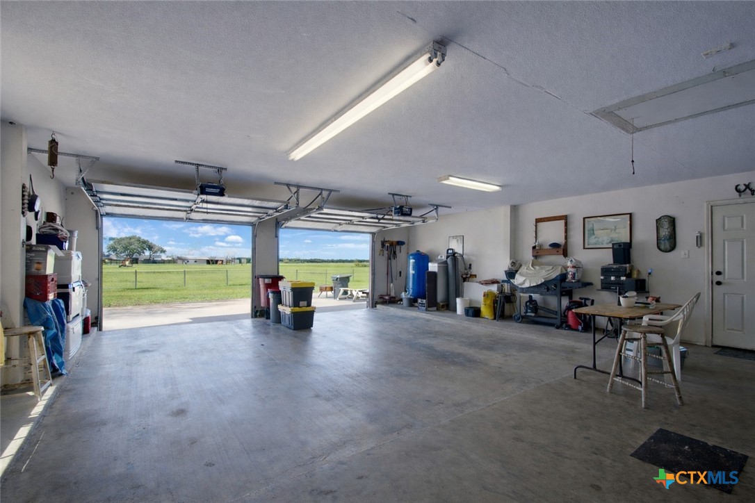 9439 Jeske Road Needville, TX 77461 - Photo 10 of 46 a view of a room with gym equipment and a large window