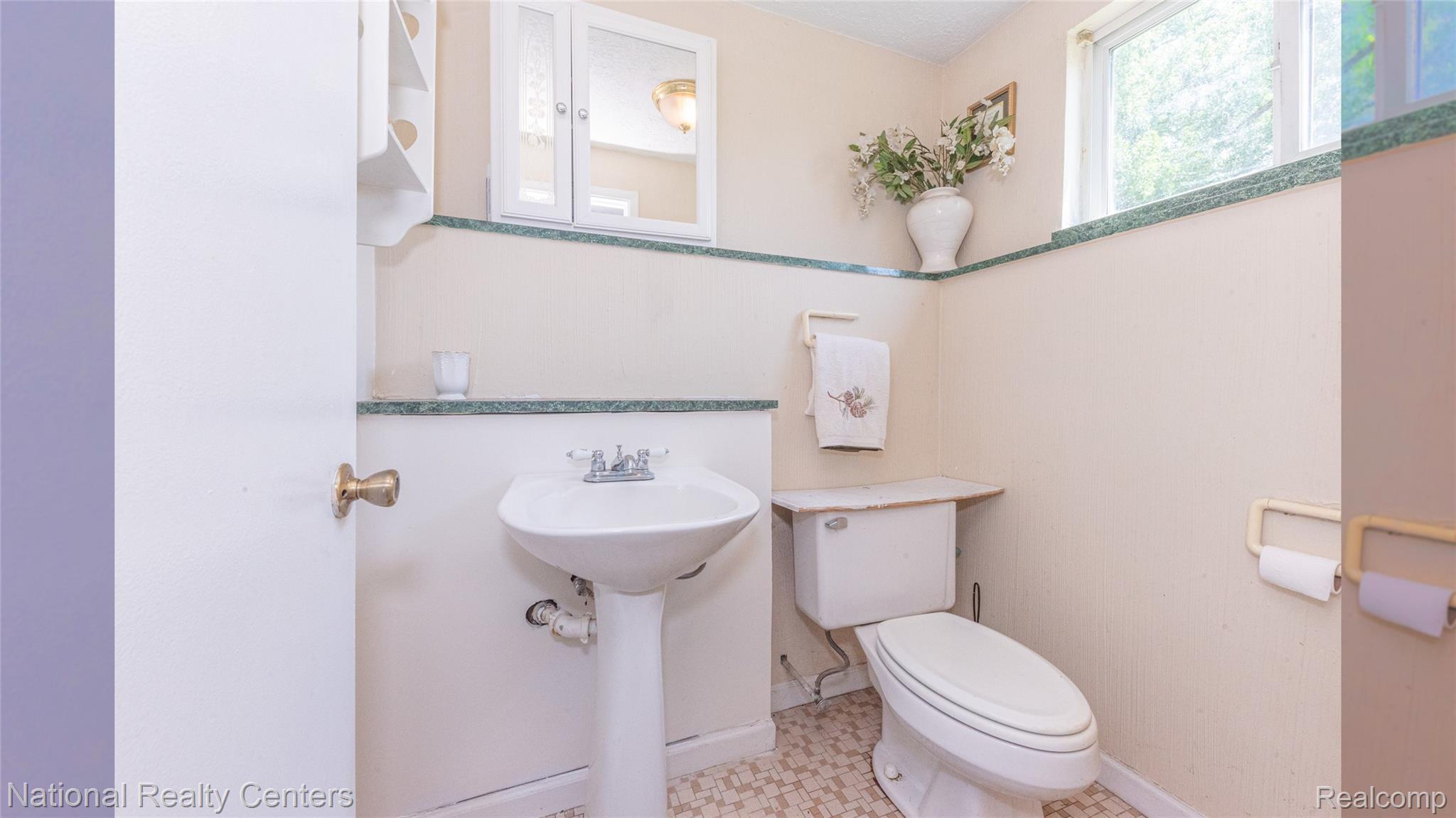 58191 8 Mile Road Northville, MI 48167 - Photo 43 of 57 Pedestal sink with chrome faucet, toilet, and window with natural light