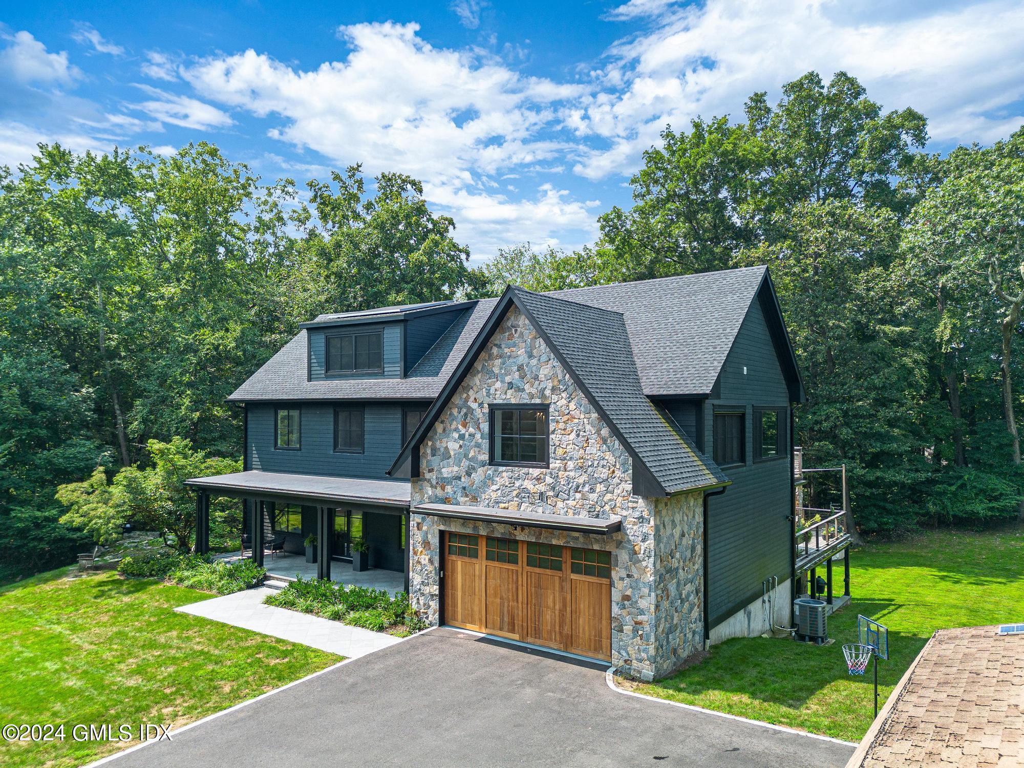 49 Indian Mill Road Cos Cob, CT 06807 - Photo 1 of 1 a front view of house with a garden and yard