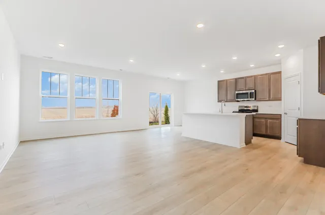 a view of a kitchen with a sink cabinets and wooden floor