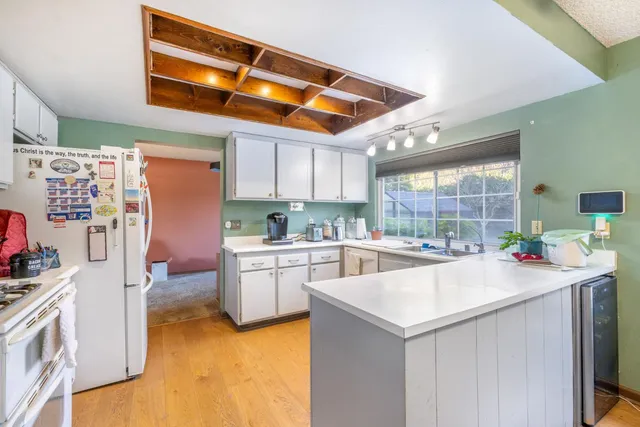 a kitchen with a sink cabinets and window