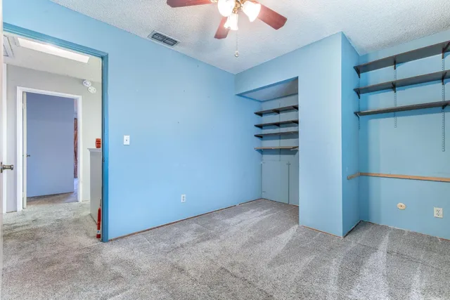 a view of a livingroom with a chandelier fan