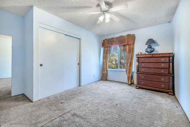 a view of room with closet and ceiling fan