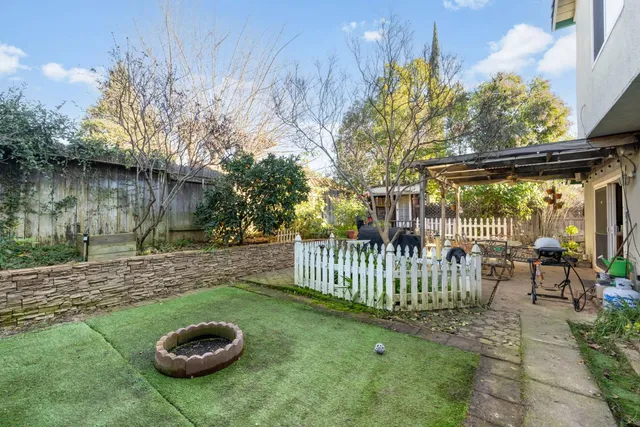 a view of a backyard with table and chairs