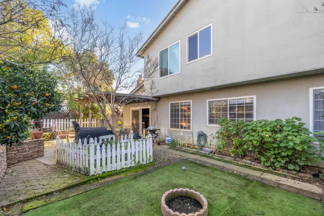 a front view of house with a garden and deck
