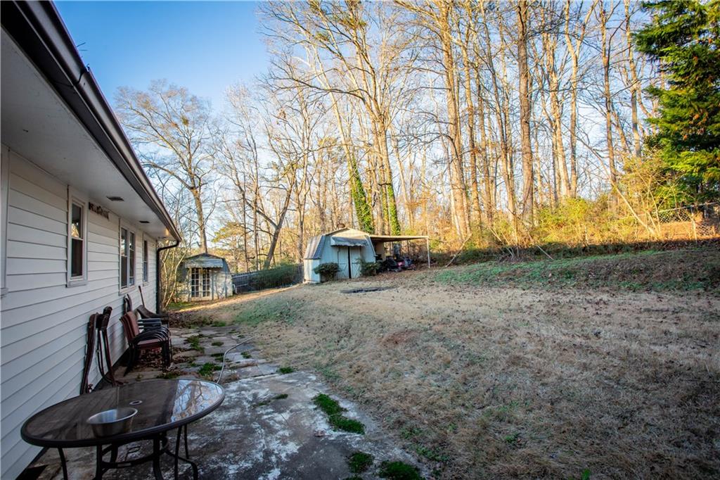 5215 Dixie Lake Road Union City, GA 30291 - Photo 12 of 12 a backyard of a house with table and chairs