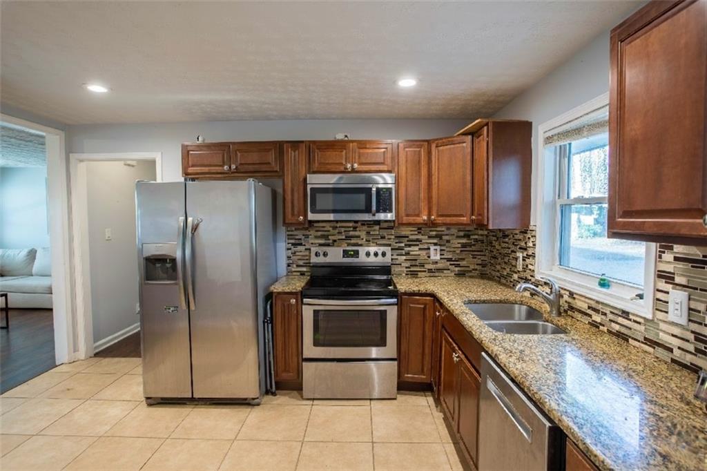 5215 Dixie Lake Road Union City, GA 30291 - Photo 3 of 12 a kitchen with a sink stove and refrigerator