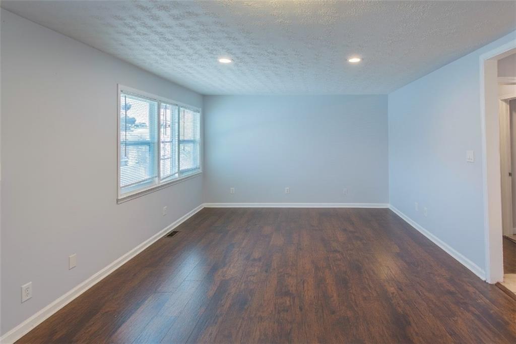 5215 Dixie Lake Road Union City, GA 30291 - Photo 5 of 12 an empty room with wooden floor and windows