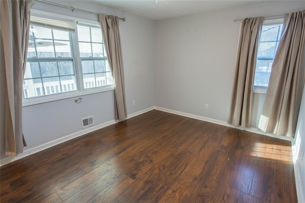 5215 Dixie Lake Road Union City, GA 30291 - Photo 7 of 12 wooden floor in an empty room with a window