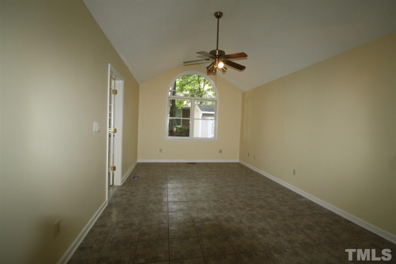 11924 Radner Way Raleigh, NC 27613 - Photo 14 of 25 an empty room with windows and chandelier fan