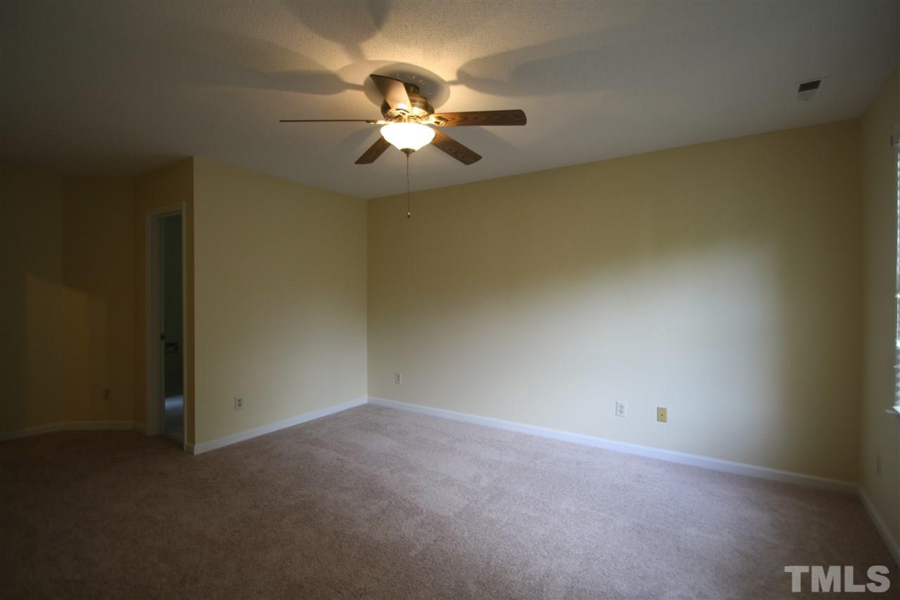 11924 Radner Way Raleigh, NC 27613 - Photo 16 of 25 a view of an empty room with a chandelier fan