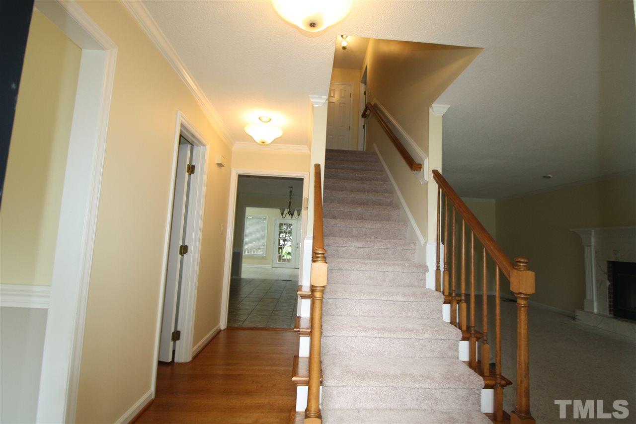 11924 Radner Way Raleigh, NC 27613 - Photo 3 of 25 a view of a hallway with wooden floor and staircase