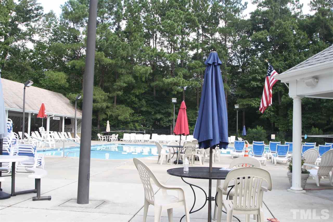 11924 Radner Way Raleigh, NC 27613 - Photo 24 of 25 a view of a patio with a table and chairs and wooden fence