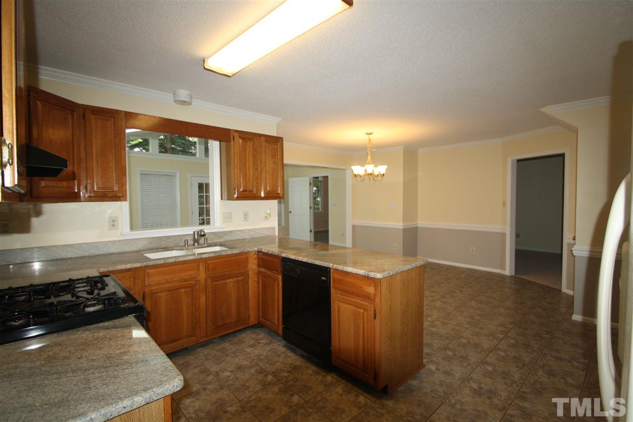 11924 Radner Way Raleigh, NC 27613 - Photo 4 of 25 a kitchen with stainless steel appliances a sink stove and refrigerator