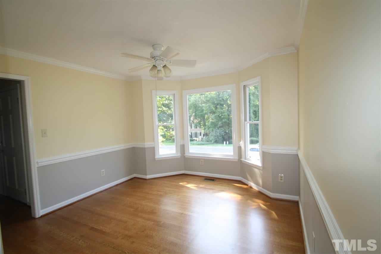 11924 Radner Way Raleigh, NC 27613 - Photo 8 of 25 a view of empty room with wooden floor and fan