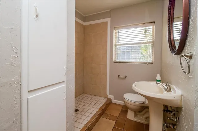 a bathroom with a sink toilet and a mirror