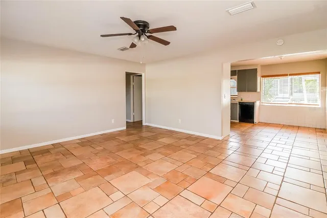a view of a livingroom with a ceiling fan and window
