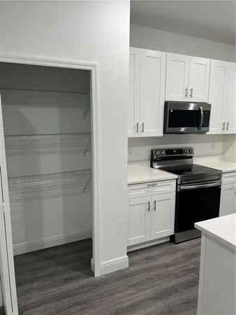 a kitchen with a sink and a stove top oven