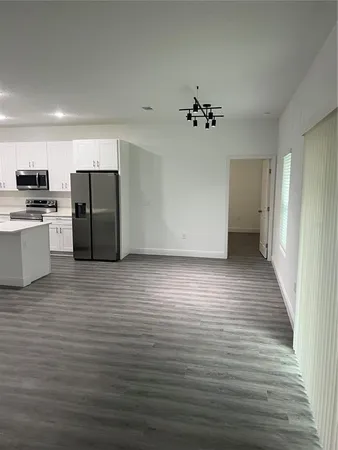 a utility room with wooden floor washer and dryer